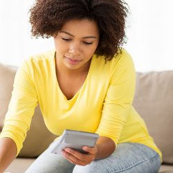 young black woman checking her finances to see if she's financially fit