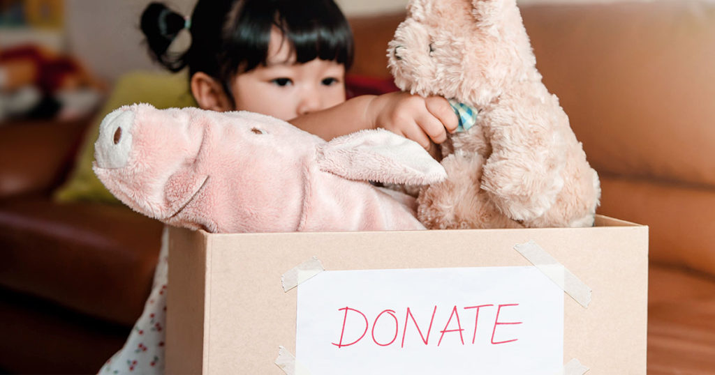 girl donating toys