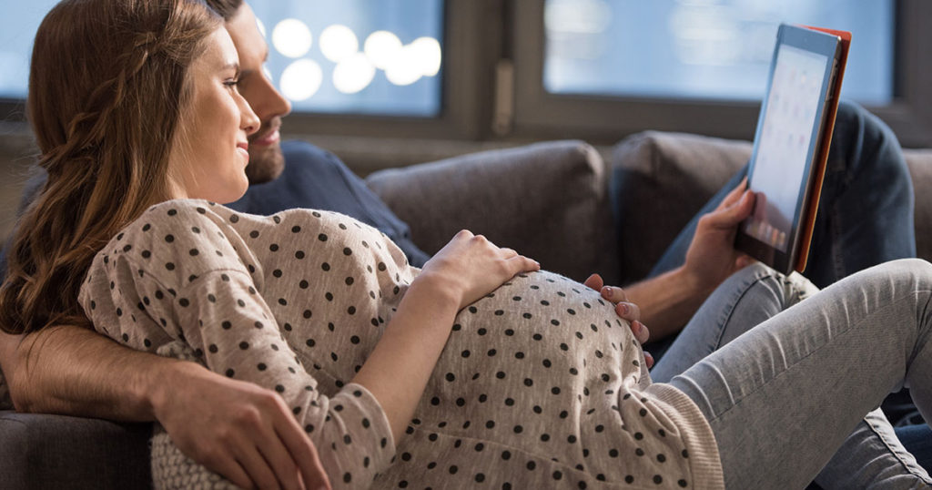 couple on couch pregnant
